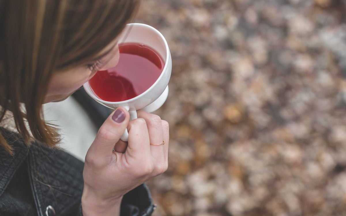 Woman holding warm cup supporting immune system during haze season