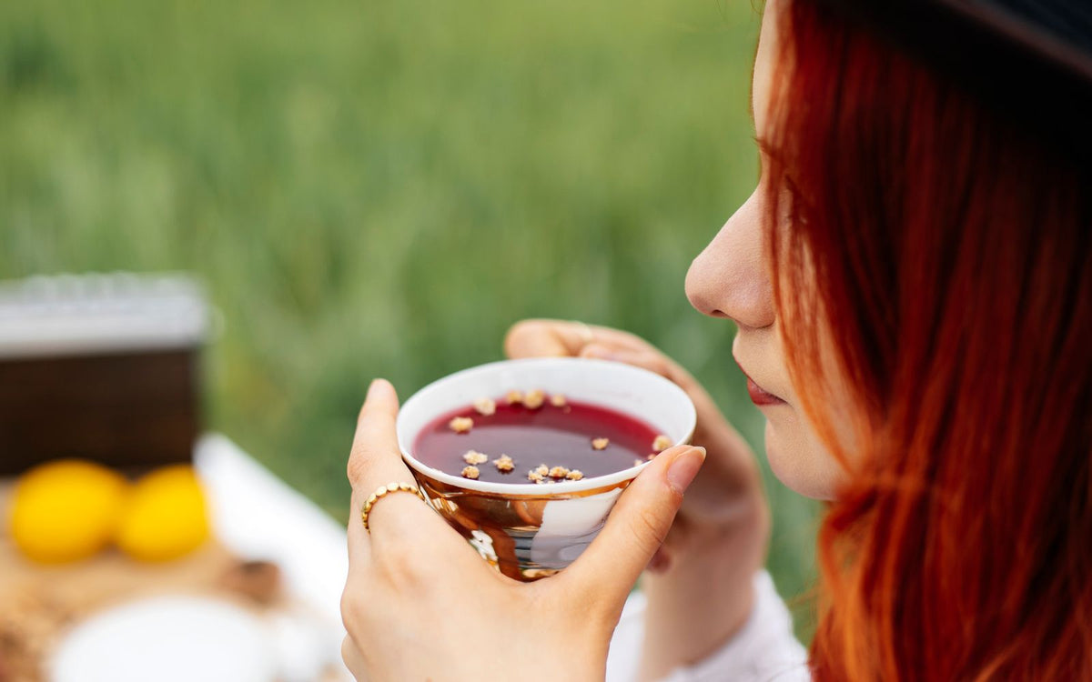 Woman enjoying wellness tea to boost immunity naturally